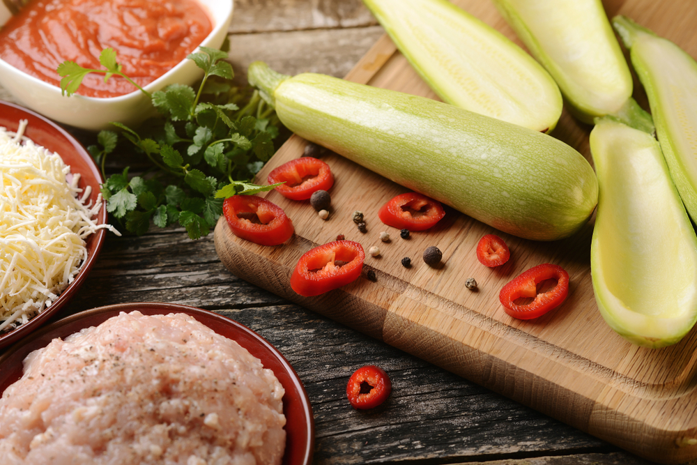Raw ingredients for baking zucchini stuffed with minced meat, tomato and cheese. Healthy food.